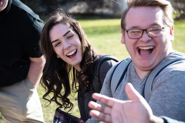 Two FLCC students laughing and enjoying themselves outside on FLCC's campus.