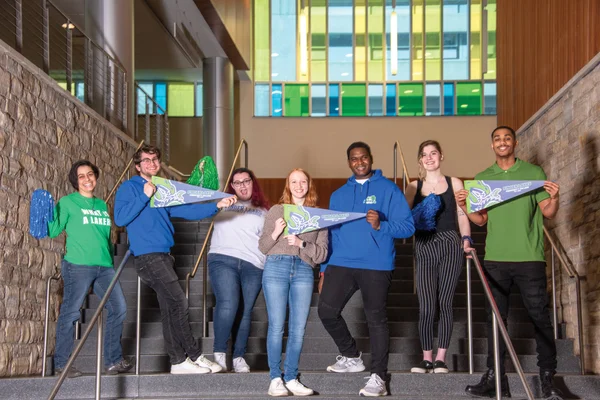 Several FLCC students welcoming guest during an admissions visit event