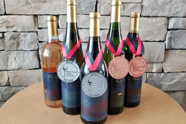 The 2018 League vintage displayed with one gold, one silver, and two bronze medals from the New York Wine Classic.