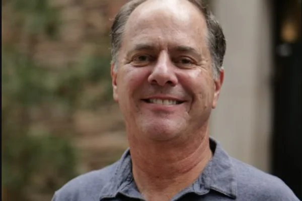 Headshot of man in polo shirt