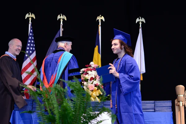Young man getting diploma at ceremony