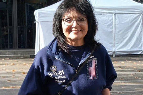 Woman smiling in uniform of 9-11 responder