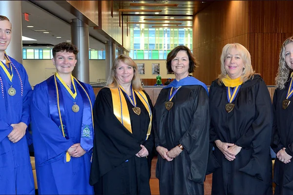 1 man, 5 women in academic regalia