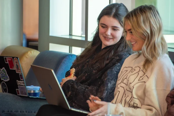 Two students work together at laptops in a lounge at Main Campus in Canandaigua.