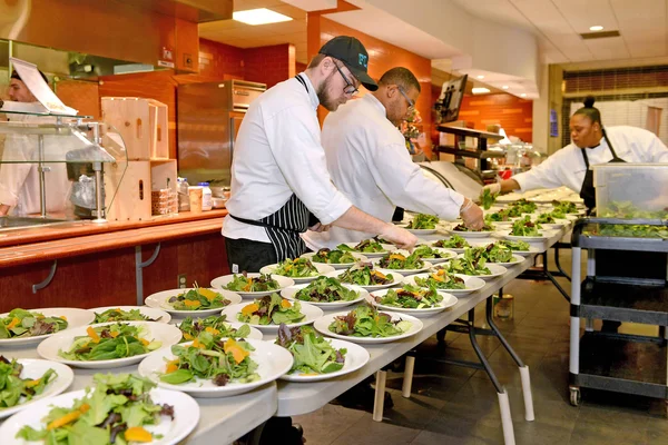 A group of culinary students prepare food for community members attending the annual Dinner at Julia event.