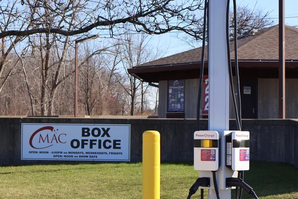 EVoke electric vehicle charging station located in the FLCC parking lot with the CMAC box office in the background.
