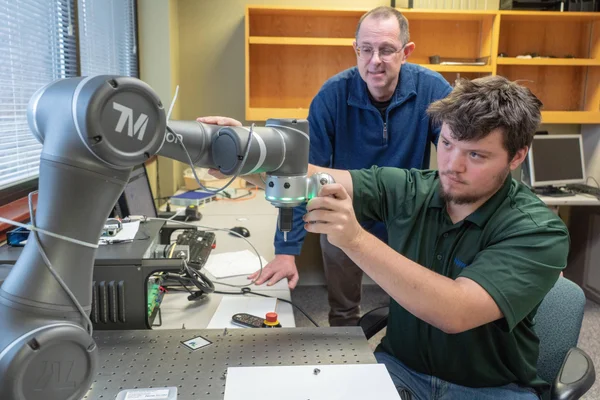 An FLCC student and faculty member work on a project using advanced manufacturing technology.