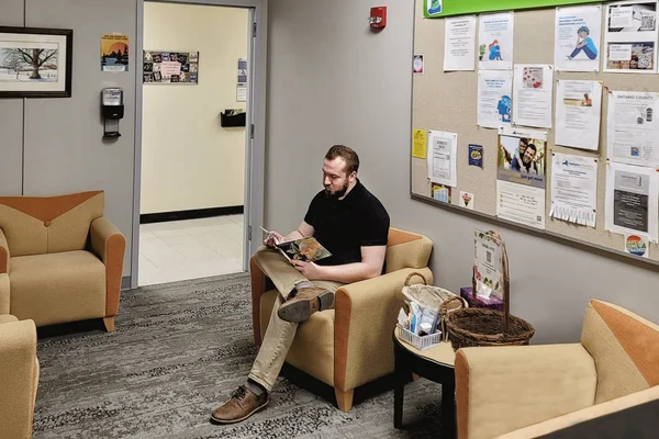 A student sitting in the Center for Student Well-Being, waiting for an appointment.