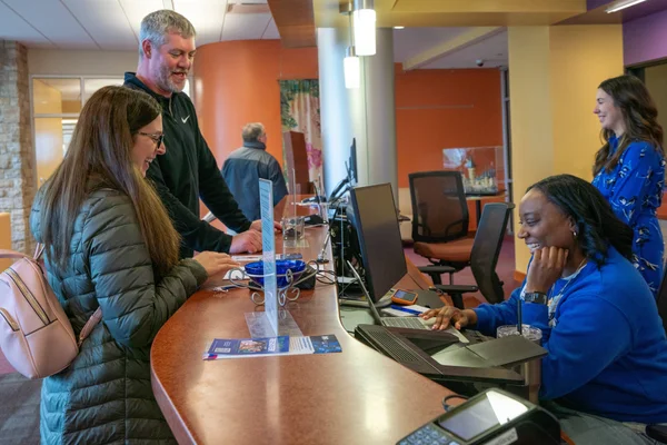 An FLCC staff member assists a student and family at the One Stop Center.