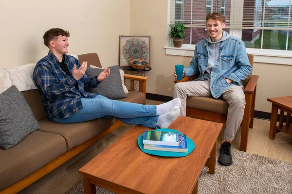 Two students hanging out in the FLCC student housing complex, the Suites at Laker Landing.
