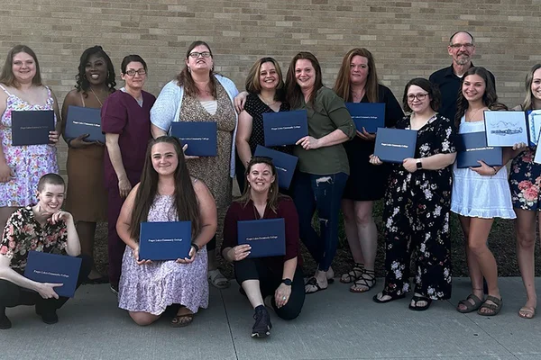 Group of 14 students posing with two FLCC staff members