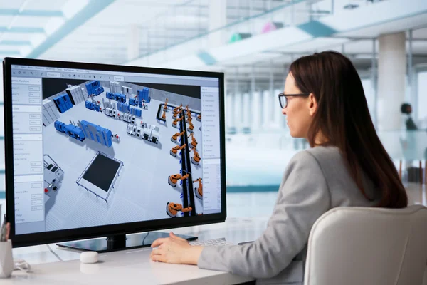 An employee works in the office of a high-tech factory.
