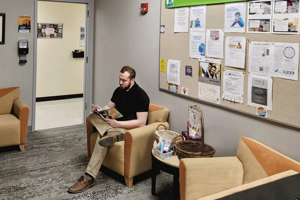 A student sitting in the Center for Student Well-Being, waiting for an appointment.