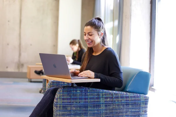 A student using a laptop computer to participate in an online class