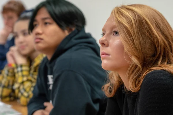 A row of students in an FLCC classroom listening to a college lecture.