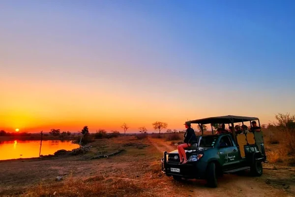 A van of students in front of an evening sunset