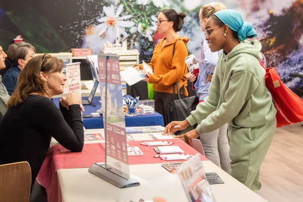 Students meeting with representatives from regional four-year colleges during a transfer event.