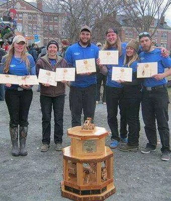 FLCC Logging Sports team with wooden trophy