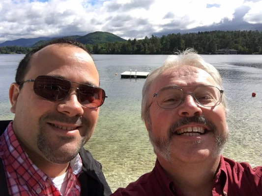 Bill Pealer and Bill White in front of a lake