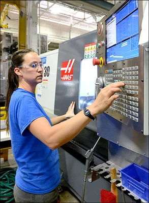 Woman operating computerized machinery