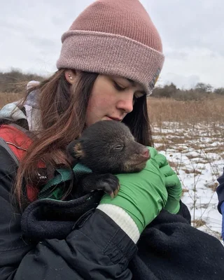 Young woman with a bear cub