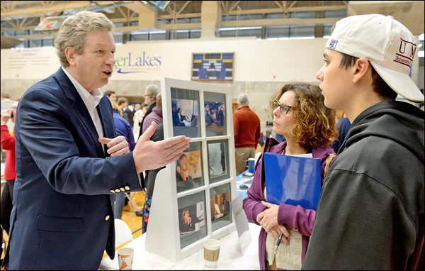 Richard Walsh, standing talking to parent, student