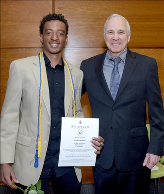 Student posing with college president