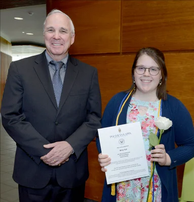 College president poses with student