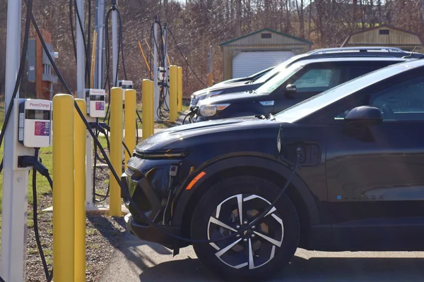 An electric vehicle plugged into an EV charging station.