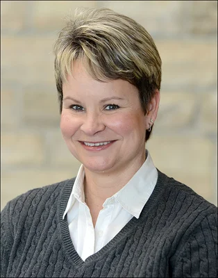 Head and shoulders photo of a woman with short hair