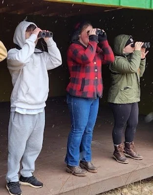 Students using binoculars at Muller Field Station.