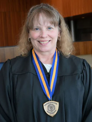 Head and shoulders image of a woman wearing a medal