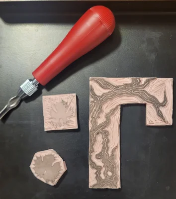 A photo of hand-cut linoleum used to make a design for a wine label