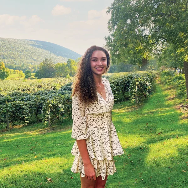 FLCC Nutrition and Dietetics student posing for a photo in front of a vineyard in midsummer.